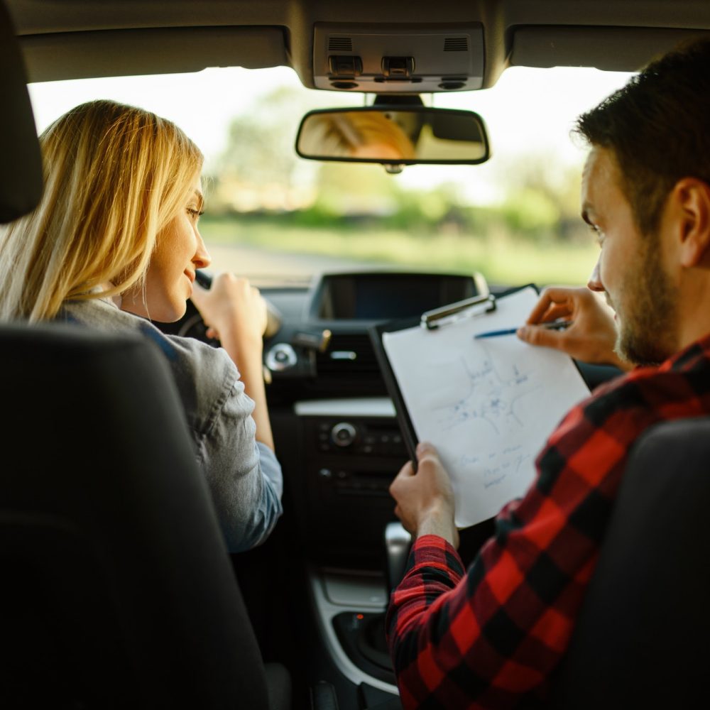 instructor-helps-woman-to-drive-the-car.jpg instructor-helps-woman-to-drive-the-car.jpg